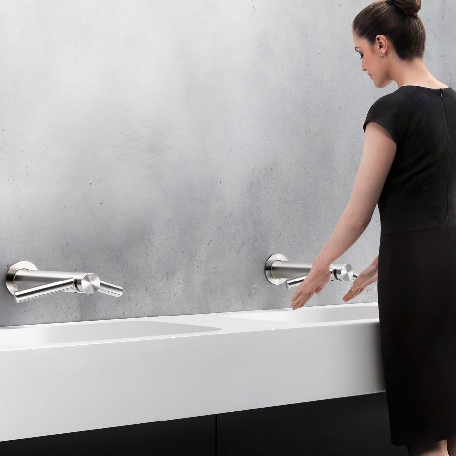 Dyson Wash + Dry in Modern Restroom Design Woman Using Dyson Wash + Dry in Modern Restroom