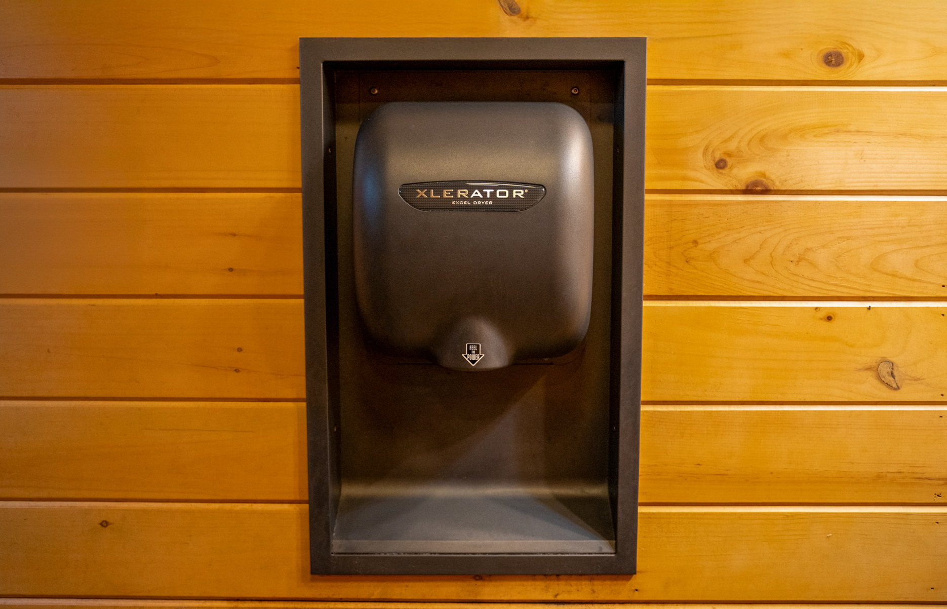 Log cabin restroom with XLERATOR hand dryer